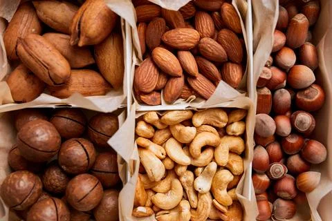 Assorted nuts in a wooden box nuts: pecan, almond, macadamia, brazil, cashew, Stock Photos