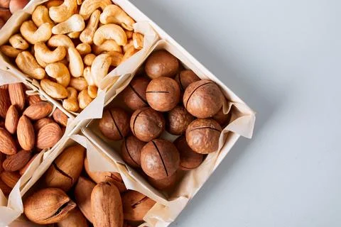 Assorted nuts in a wooden box nuts: pecan, almond, macadamia, brazil, cashew, Stock Photos