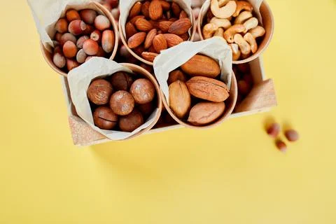 Assorted nuts in a wooden box nuts: pecan, almond, macadamia, brazil, cashew, Stock Photos