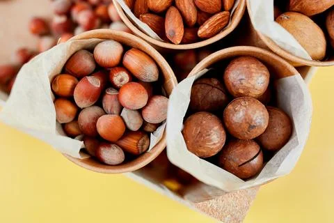 Assorted nuts in a wooden box nuts: pecan, almond, macadamia, brazil, cashew, Stock Photos