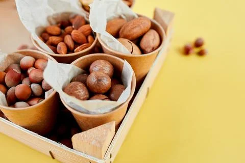 Assorted nuts in a wooden box nuts: pecan, almond, macadamia, brazil, cashew, Stock Photos