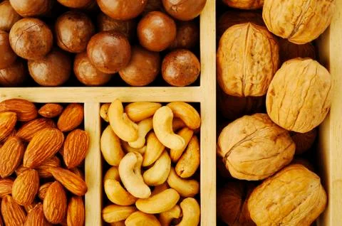 Assorted nuts in wooden box Stock Photos