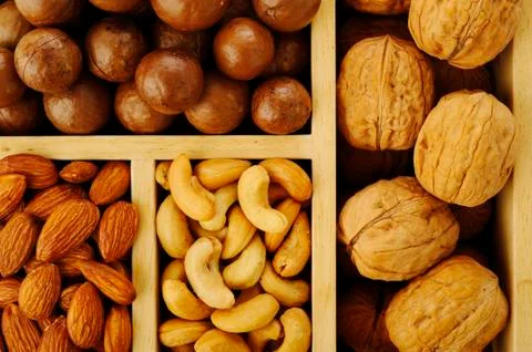 Assorted nuts in wooden box Stock Photos
