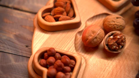 Assorted Nuts on Wooden Cutting Board Stock Footage 273710486