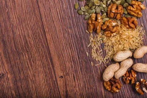 Assorted nuts on wooden surface Stock Photos