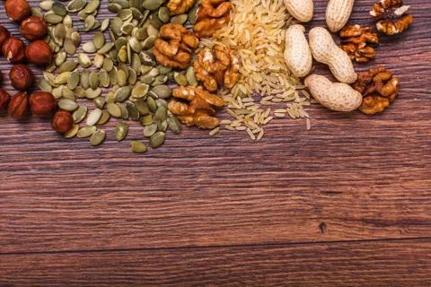 Assorted nuts on wooden surface Stock Photos