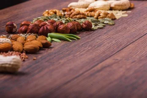 Assorted nuts on wooden surface Stock Photos