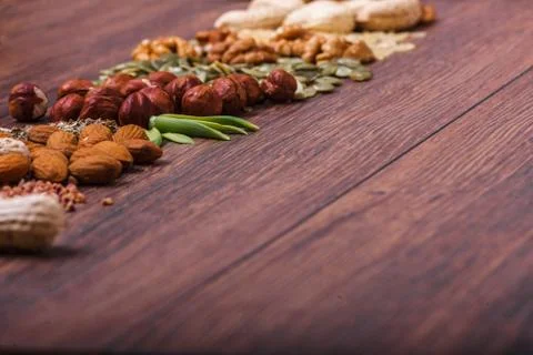 Assorted nuts on wooden surface Stock Photos