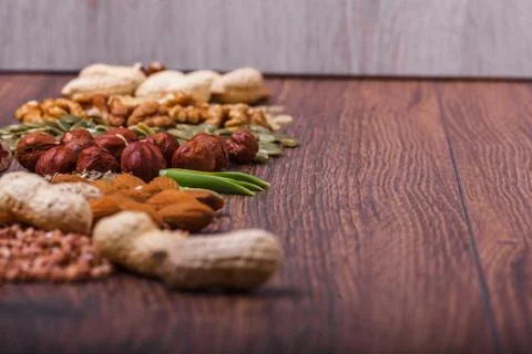 Assorted nuts on wooden surface Stock Photos