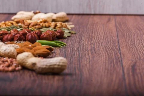 Assorted nuts on wooden surface Stock Photos