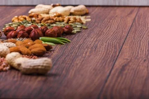 Assorted nuts on wooden surface Stock Photos