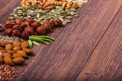 Assorted nuts on wooden surface Stock Photos