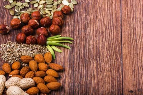 Assorted nuts on wooden surface Stock Photos