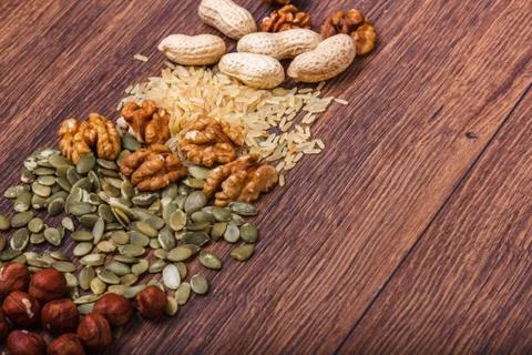 Assorted nuts on wooden surface Stock Photos