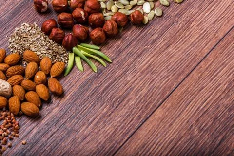 Assorted nuts on wooden surface Stock Photos