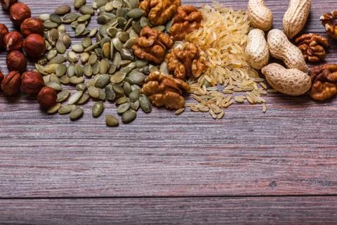 Assorted nuts on wooden surface Stock Photos
