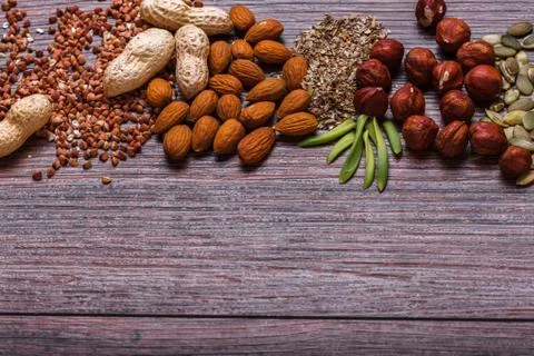 Assorted nuts on wooden surface Stock Photos
