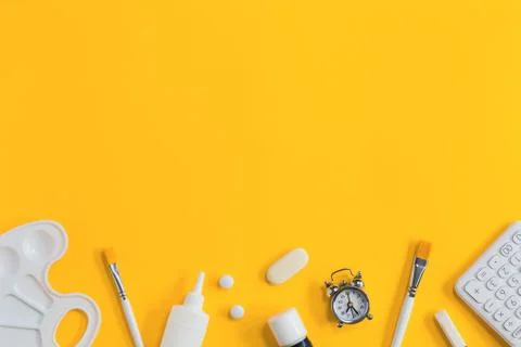 Assorted office and school white stationery on yellow Stock Photos
