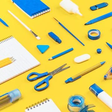 Assorted office and school white and blue stationery on yellow Stock Photos