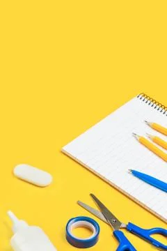 Assorted office and school white and blue stationery on yellow Stock Photos