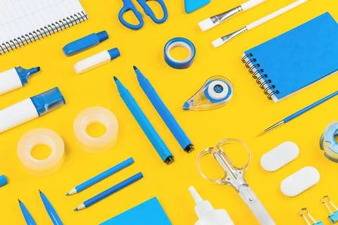 Assorted office and school white and blue stationery on yellow Stock Photos