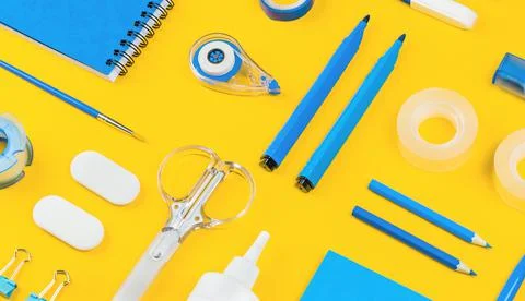 Assorted office and school white and blue stationery on yellow Stock Photos