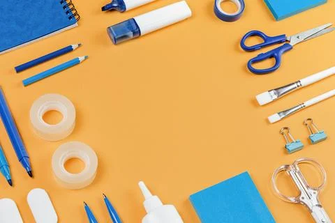 Assorted office and school white and blue stationery on yellow Stock Photos