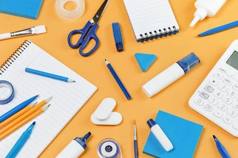Assorted office and school white and blue stationery on yellow Stock Photos