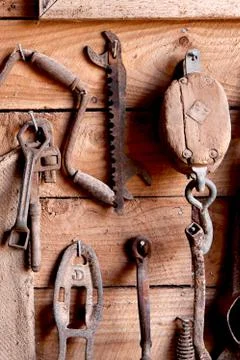 Assorted old work tools on wooden wall Stock Photos
