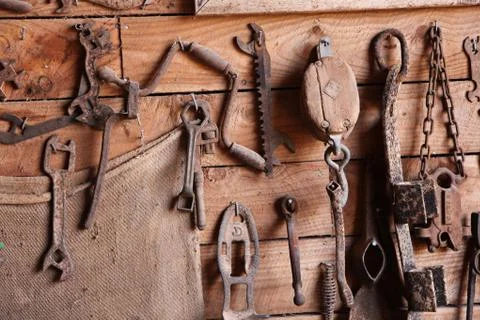 Assorted old work tools on wooden wall Stock Photos