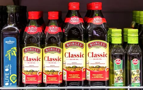 Assorted olive oils in bottles ready for sale in the superstore Stock Photos