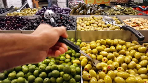 Assorted Olives Spoon and Hand 4K Stock Footage 51774930