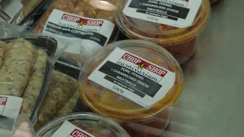 Assorted Packaged Sausages and Ready Meals Displayed at Sydney Market Counter Stock Footage 345800795