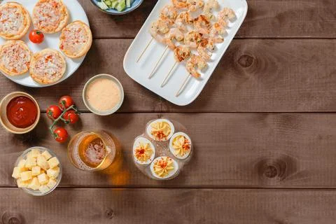 Assorted Party Snacks and Drinks on Wooden Table Stock Photos