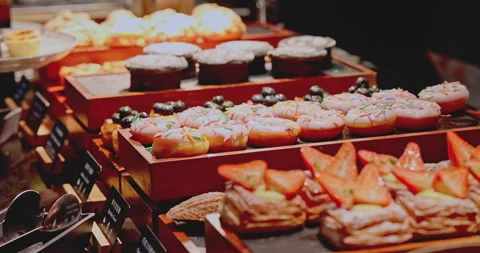 Assorted pastries and donuts on display at breakfast buffet 库存影片 344479574