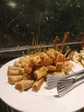 Assorted pastries and traditional Middle Eastern sweets displayed on a lavish Stock Photos