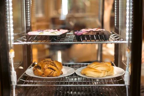 Assorted Pastries Behind Bakery Display Glass Stock Photos