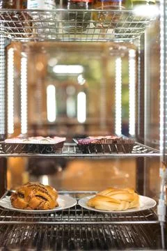 Assorted Pastries Behind Bakery Display Glass Stock Photos
