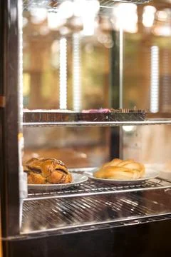 Assorted Pastries Behind Bakery Display Glass Stock Photos