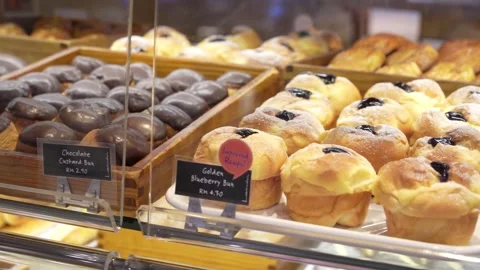 Assorted pastry and bread arranged on tray selling at bakery shop. 動画素材 266101638