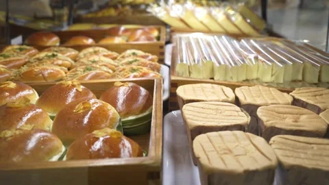Assorted pastry and bread arranged on tray selling at bakery shop Видео 269921534