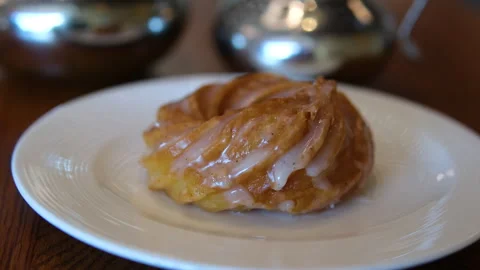 Assorted pastry set with croissants, butter and espresso on a wooden table on a Stock Footage 318465663