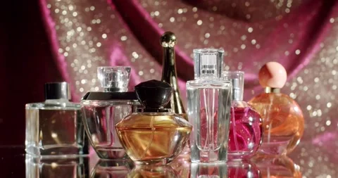 Assorted Perfume Bottles on Sparkling Background for Elegant Presentation Stock Footage 313052690