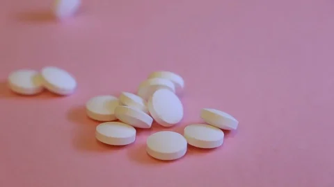 Assorted pharmaceutical medicine pills, tablets and capsules and bottle on pi Video stock 113418564
