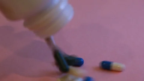 Assorted pharmaceutical medicine pills, tablets and capsules and bottle on pi Stock-Footage 113418580
