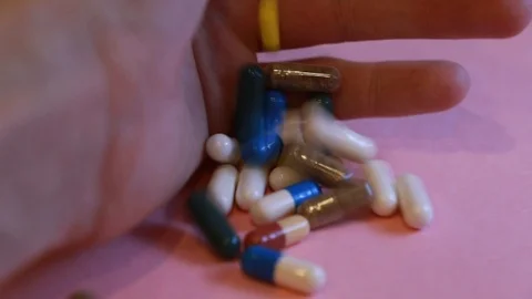 Assorted pharmaceutical medicine pills, tablets and capsules and bottle on pi Stock Footage 113418618