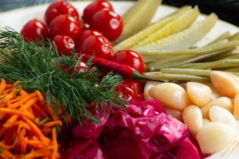 Assorted pickled and salted vegetables in a plate. Stock Photos