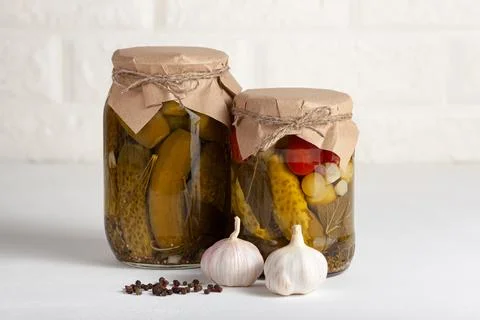 Assorted pickled vegetables in glass jars with garlic and spices Stock Photos