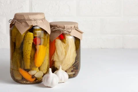 Assorted pickled vegetables in jars with garlic. Copy space Stock Photos
