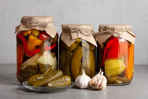 Assorted Pickled Vegetables in Jars with Garlic Stock Photos